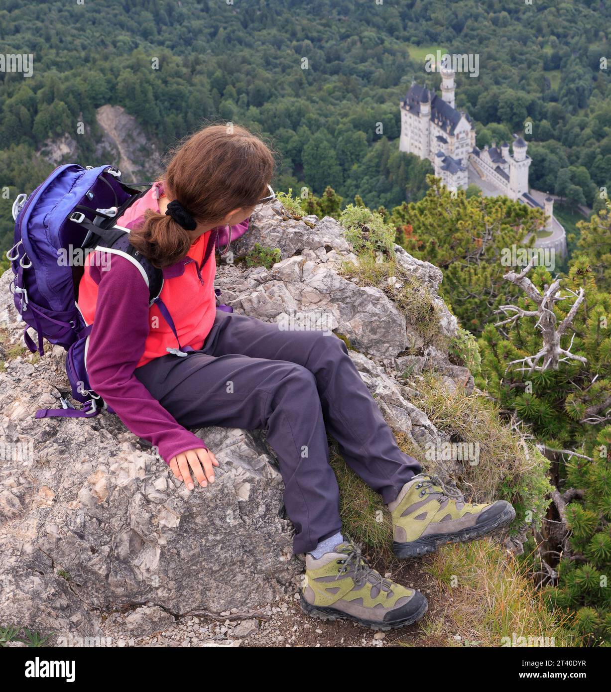 Aerial view of Neuschwanstein Castle with teenager hiking girl on the foreground Stock Photo