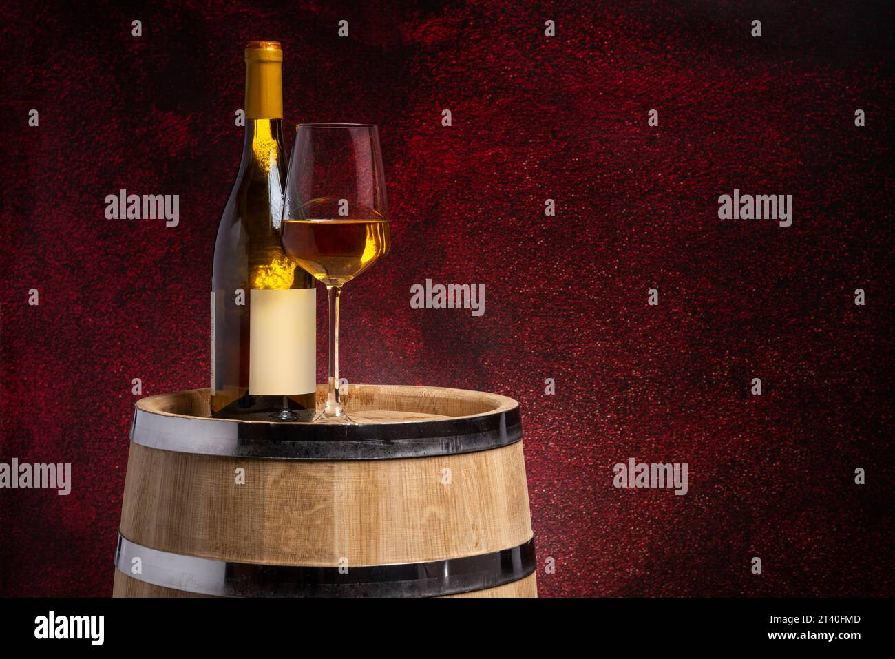 Wine glass and bottle on oak barrel on dark red background Stock Photo ...
