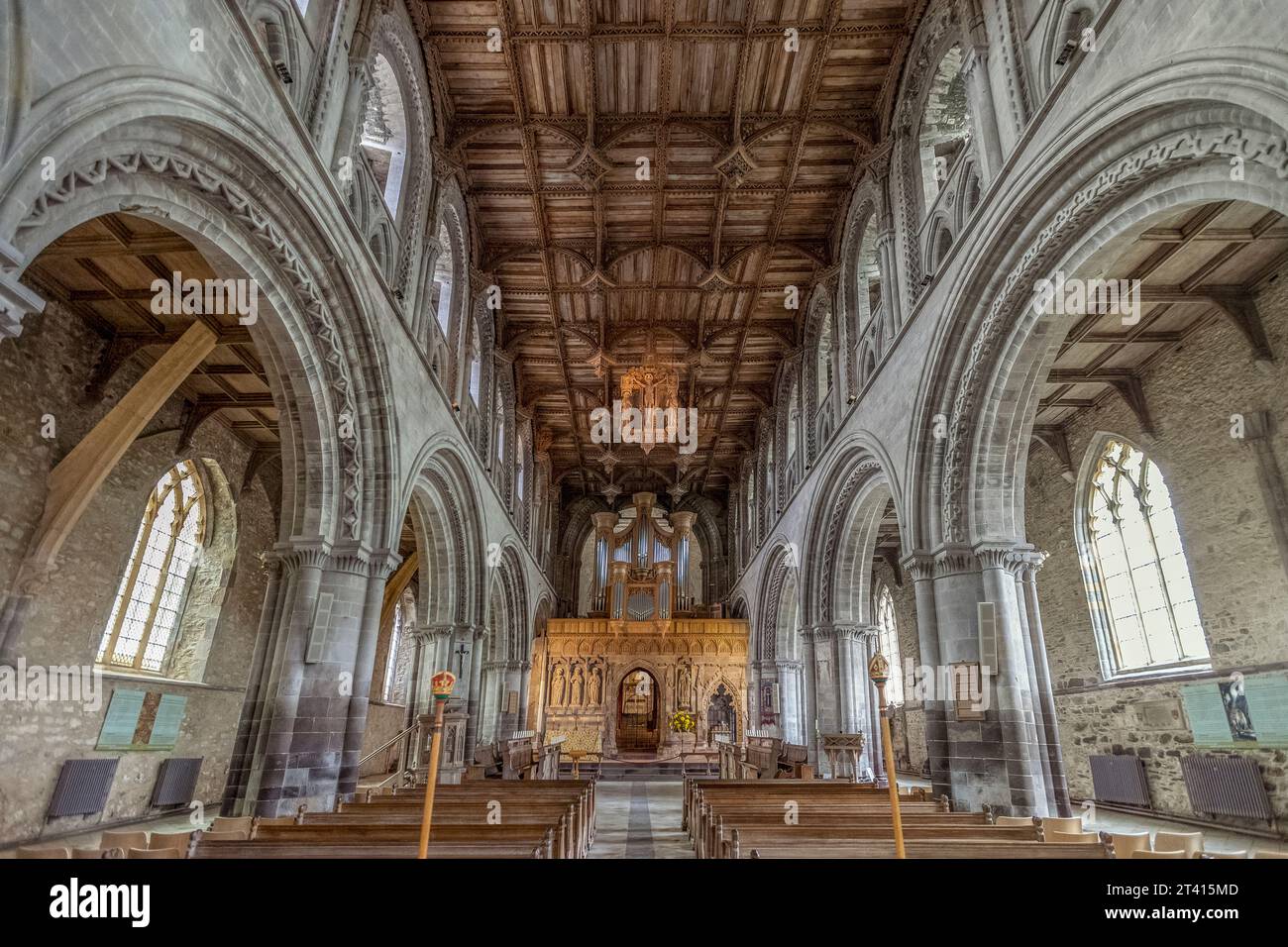 Carved wooden ceiling of St Davids Cathedral, with the suspended 20th-century replacement crucifixion carving, Pembrokeshire, south-west Wales Stock Photo
