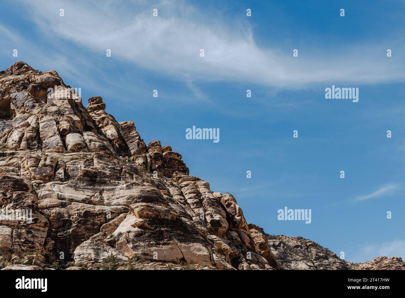 Wispy white cloud in blue sky above Red Rock Canyon National Conservation Area in Nevada, USA. Stock Photo