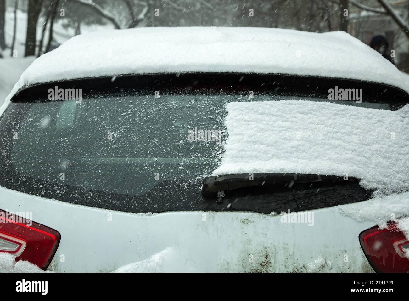 the back door of a crossover half of the window covered with a layer of ...