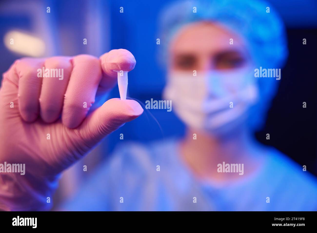 Embryologist is showing cryovial filled with cryopreserved biological samples Stock Photo