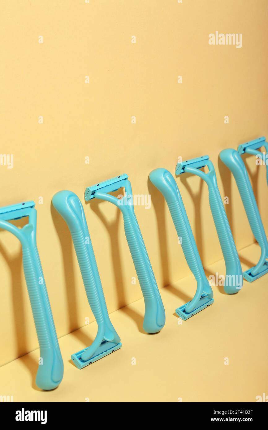 Many safety razors on yellow background Stock Photo