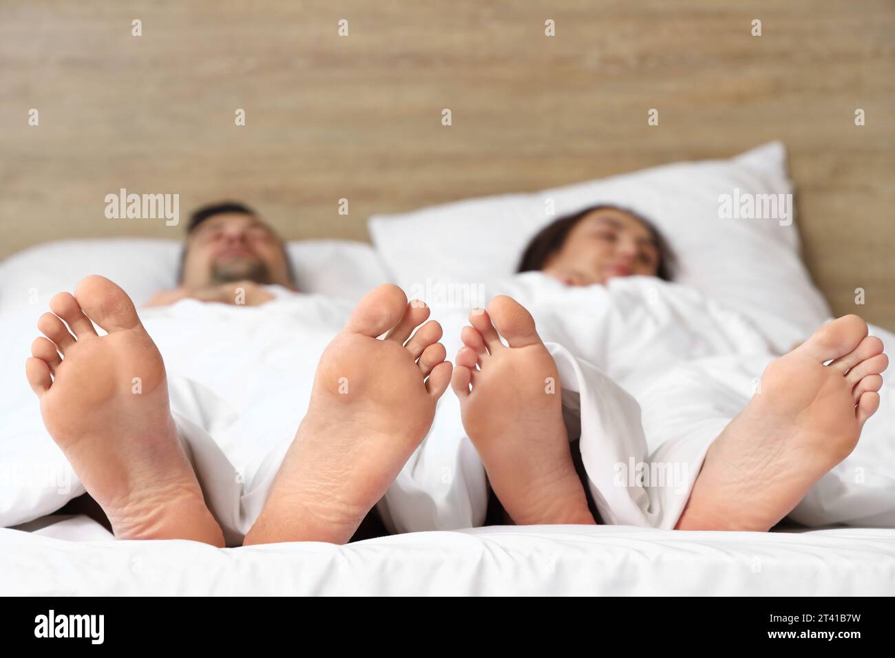 Feet of young couple sleeping in bedroom, closeup Stock Photo Alamy