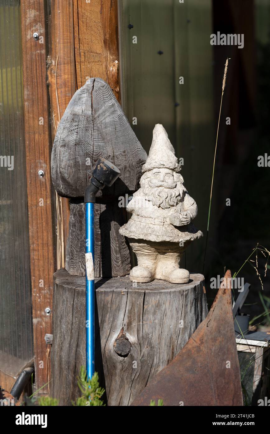 Garden gnome and watering wand at the Minam River Lodge, Oregon. Stock Photo
