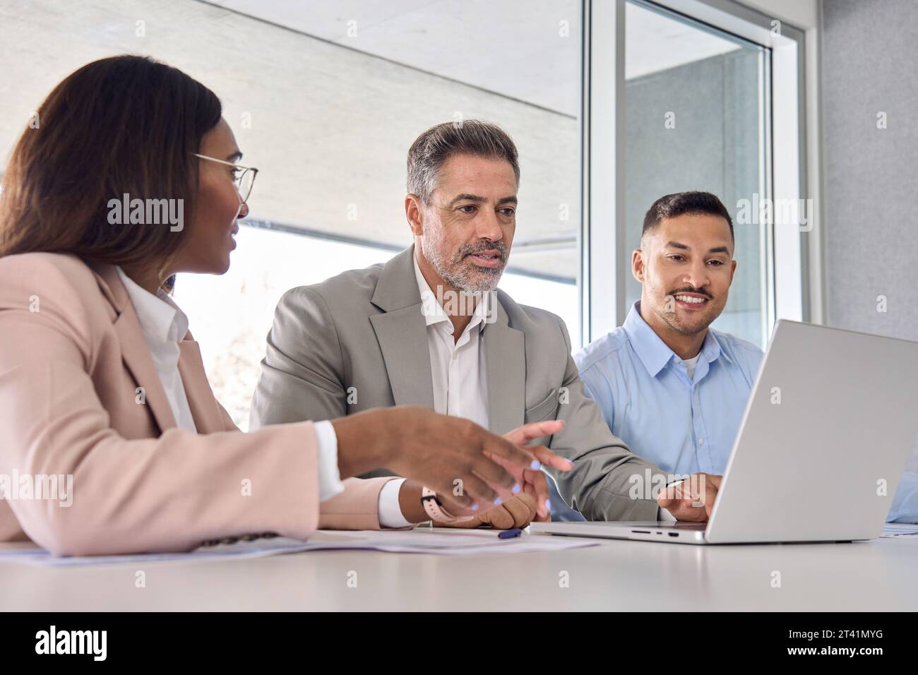 International executives team using laptop laptop discussing digital data. Stock Photo