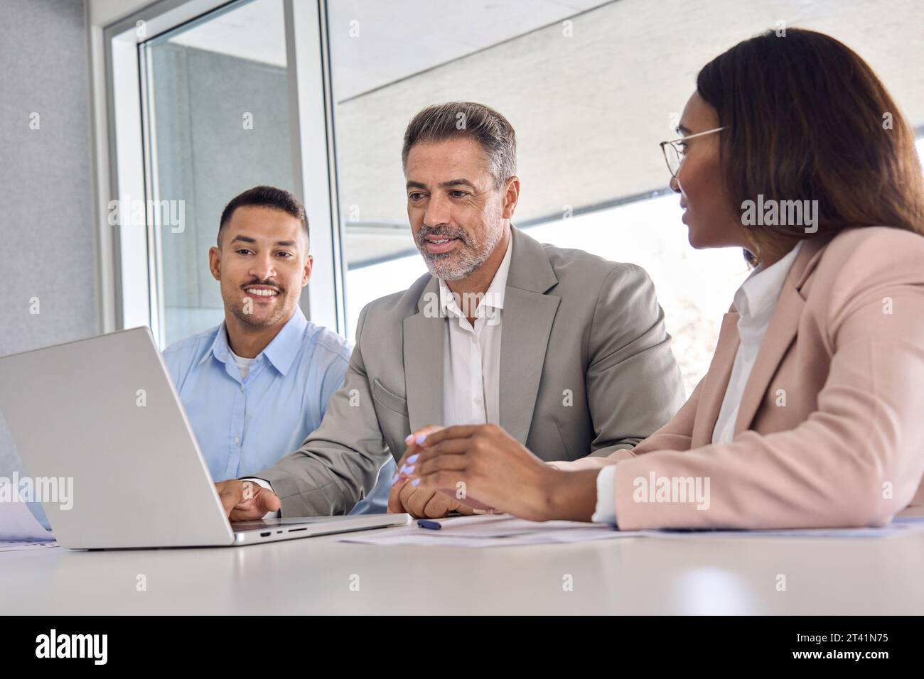 International executives team using laptop laptop discussing digital data. Stock Photo