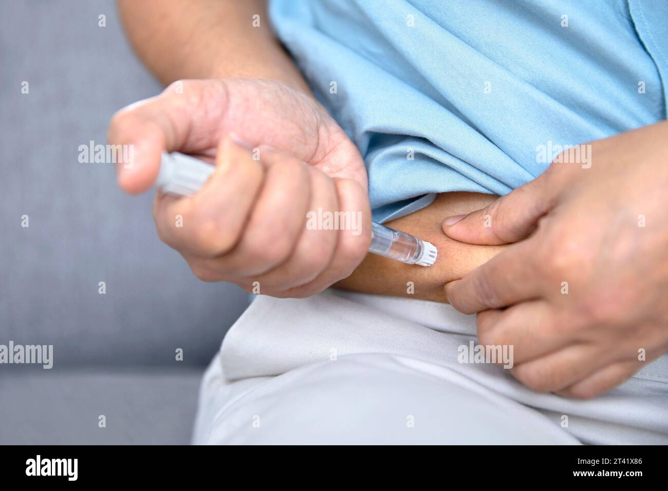 Man self-injecting Stock Photo