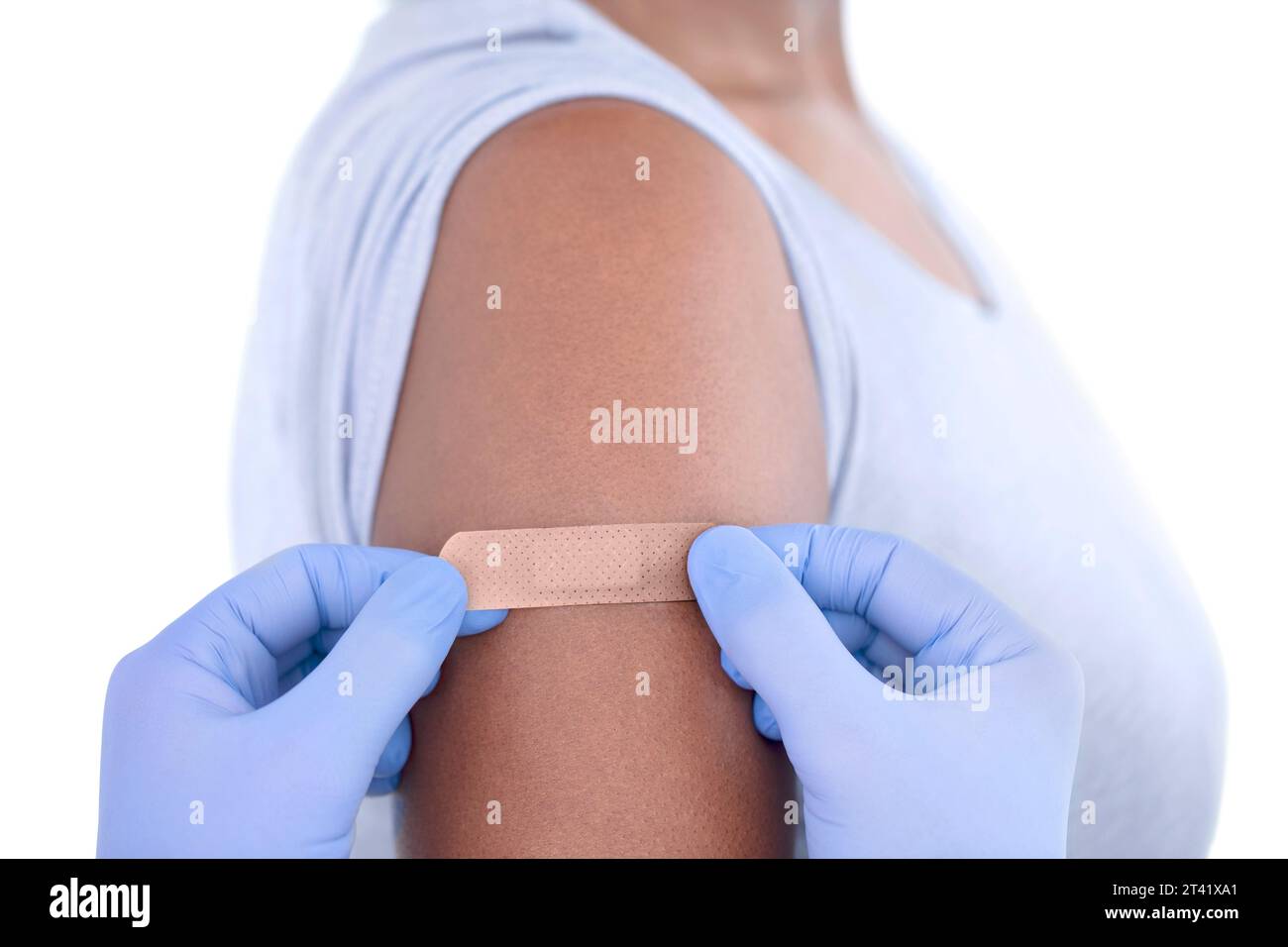 Plaster being applied to woman's arm Stock Photo
