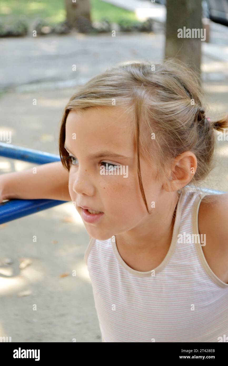 The girl goes in for sports on the Playground on the street. exercises, stretching, exercises. Healthy lifestyle. Fitness training. Workout. Girl goes Stock Photo
