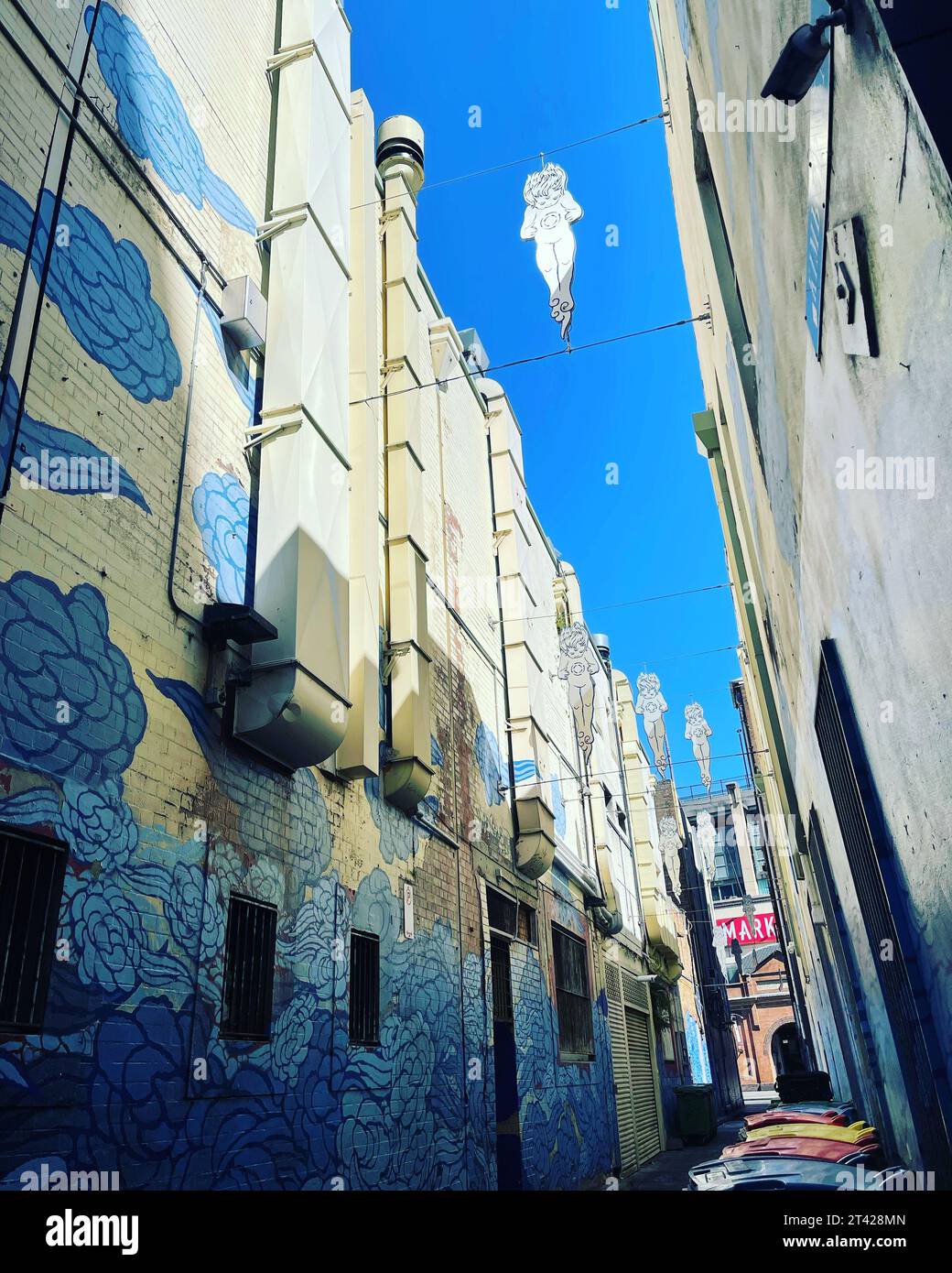 A vibrant mural adorning the side of a building in the back streets of ...