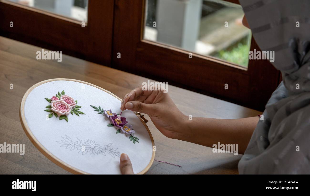 Floral Elegance: Hand-Stitched Embroidery on Wooden Hoop Stock Photo