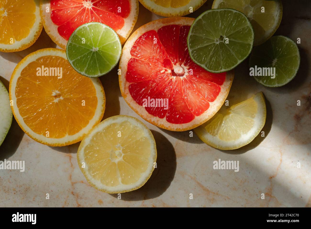 Image of an isolated selection of limes and oranges displayed on a