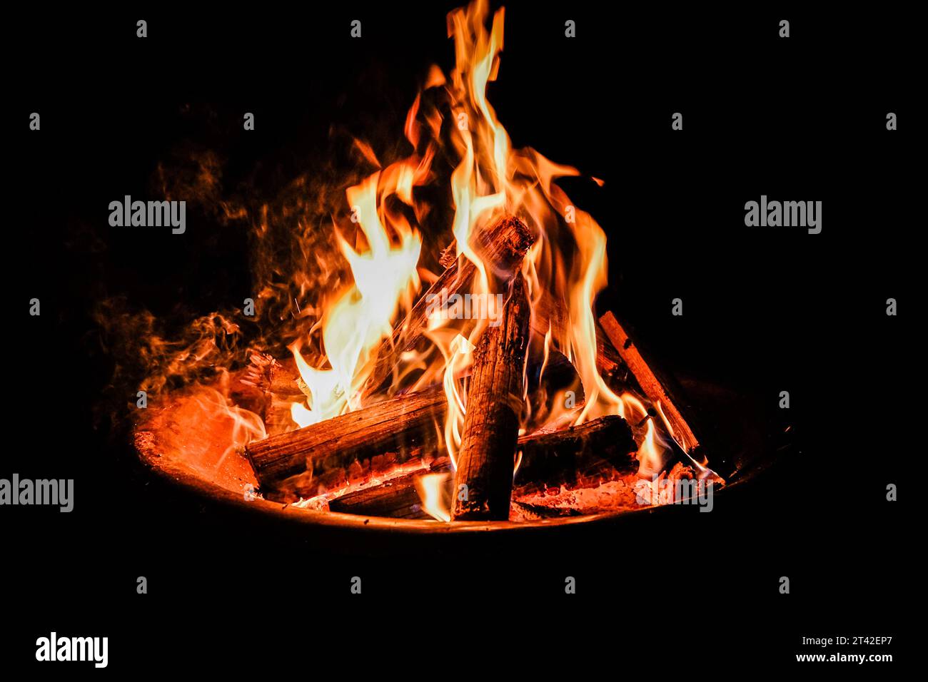 A blazing bonfire lit up against a night sky Stock Photo