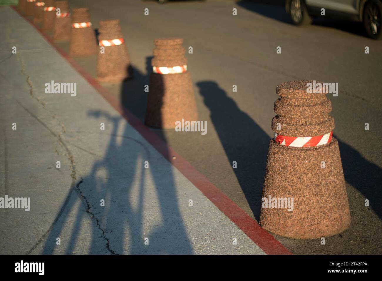 Pedestrian area. Parking limiter. Stone pillars on road. Bike path in ...