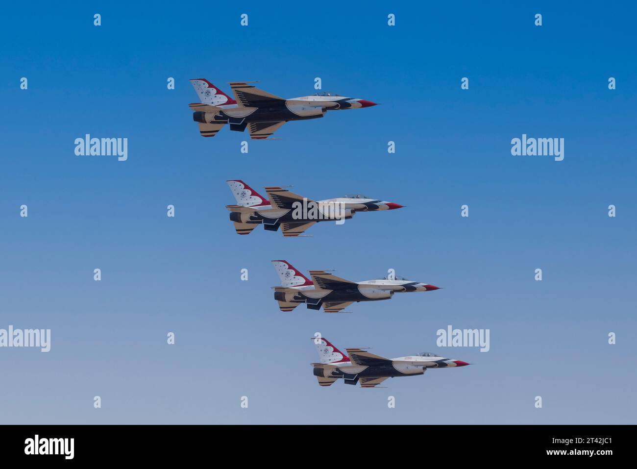A group of fighter jets in midair, engaged in a thrilling race against each other Stock Photo