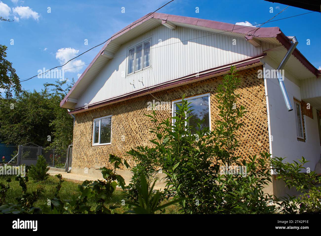 to make the facade of the house gluing foam boards Stock Photo