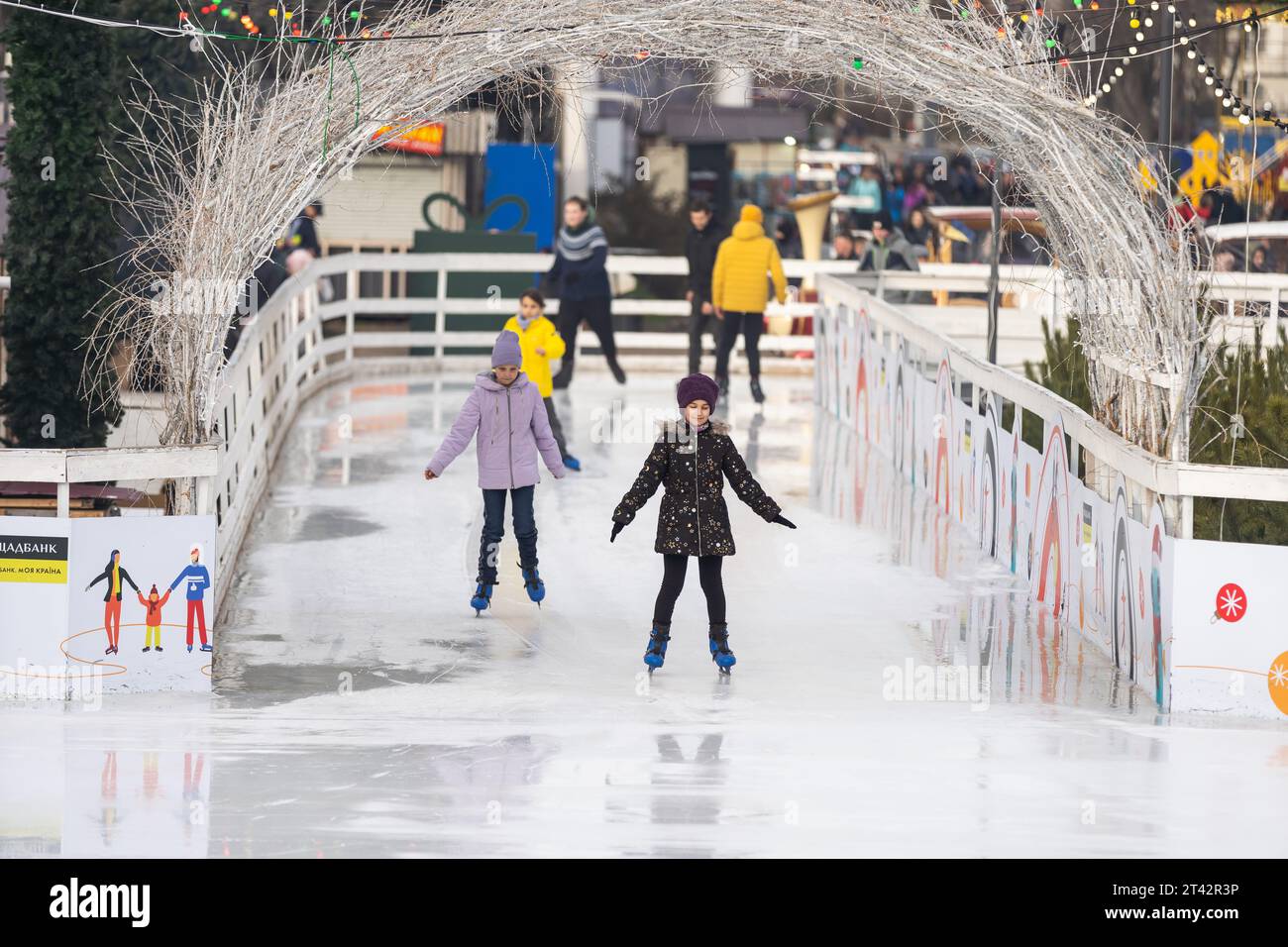 KYIV, UKRAINE - 1 January, 2023: Ice-skating people. People have fun in ...