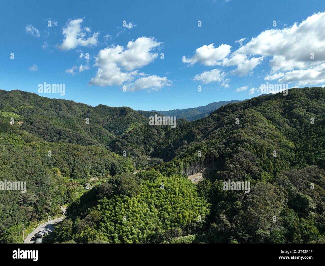 A scenic landscape featuring lush green hills under the blue sky Stock ...