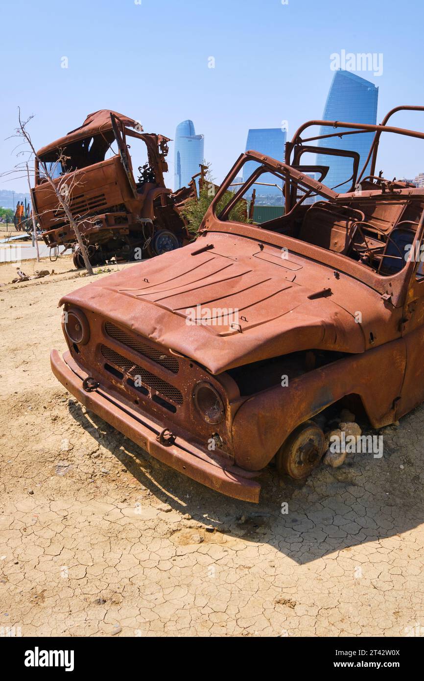 Burned out, rusted wreckage of a vehicle. At the Military Trophy Park, commemorating the 2020 Nagorno-Karabakh war. In Baku, Azerbaijan. Stock Photo