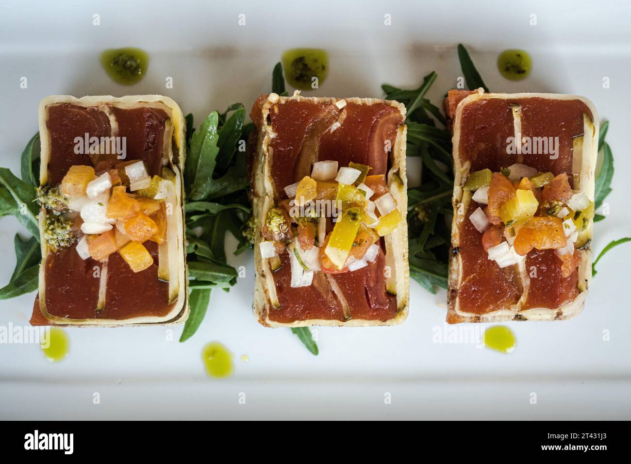 Overhead view of three slices of a Courgette and tomato terrine Stock Photo