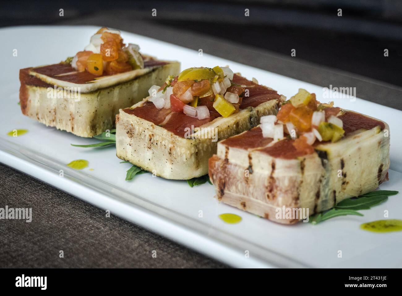 Close-up of three slices of a Courgette and tomato terrine Stock Photo
