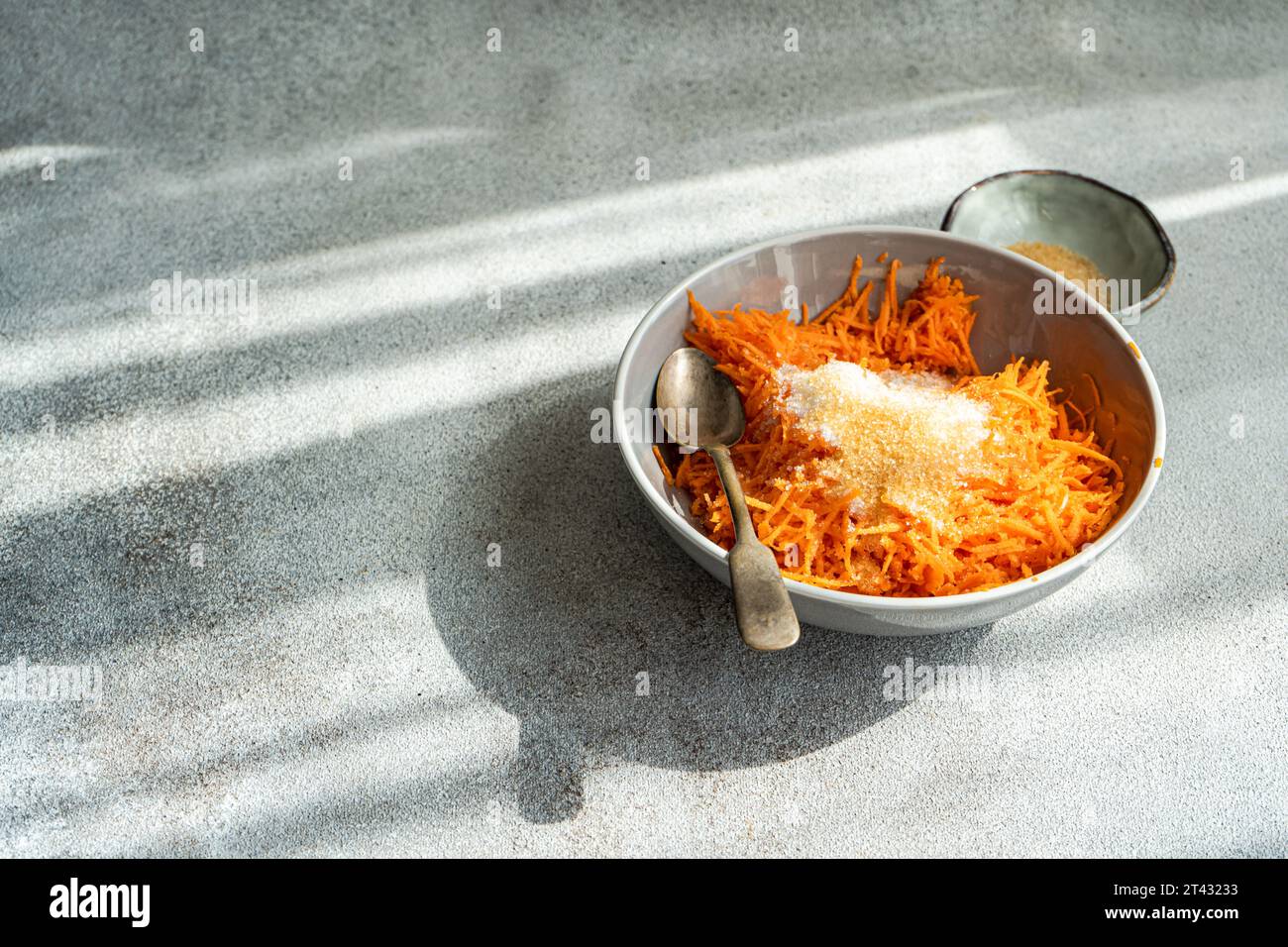 Overhead view of a dessert with grated Carrot and brown sugar Stock Photo