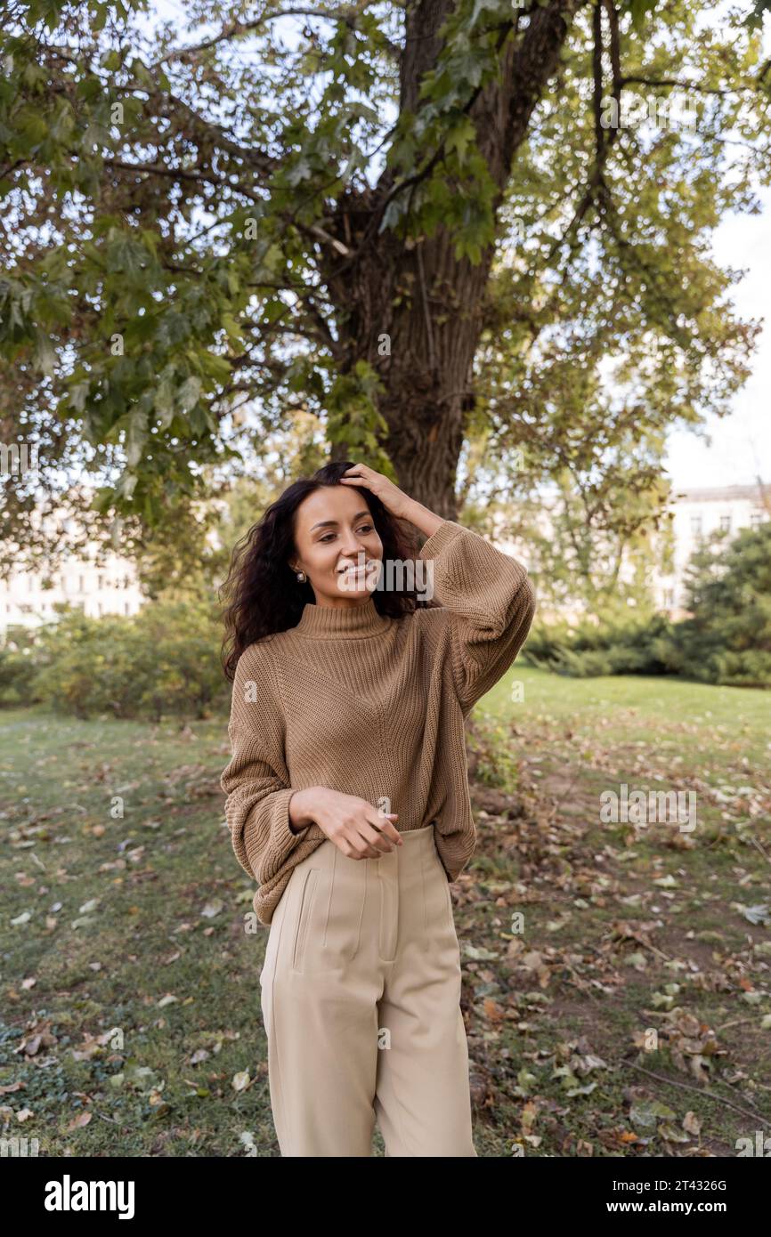 Smiling woman standing in a park on a sunny autumn day, Belarus Stock Photo