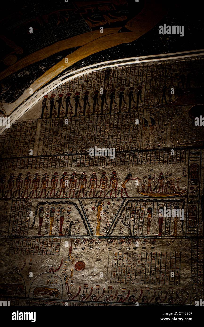 Majestic hieroglyphics line the curved walls of a royal tomb Stock Photo