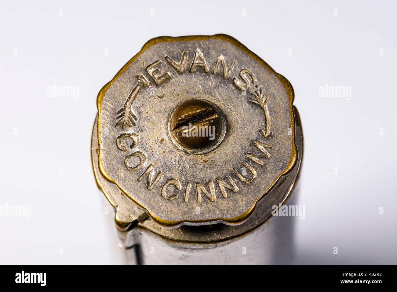 An Evans Patent Concinnum Machine, a vintage cigarette rolling device.  End view showing the knob which turns the brass rollers. Stock Photo