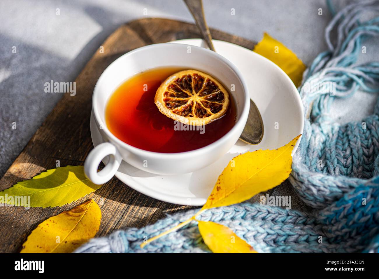Overhead view of a cup of spiced black tea with lemon and autumnal styling Stock Photo