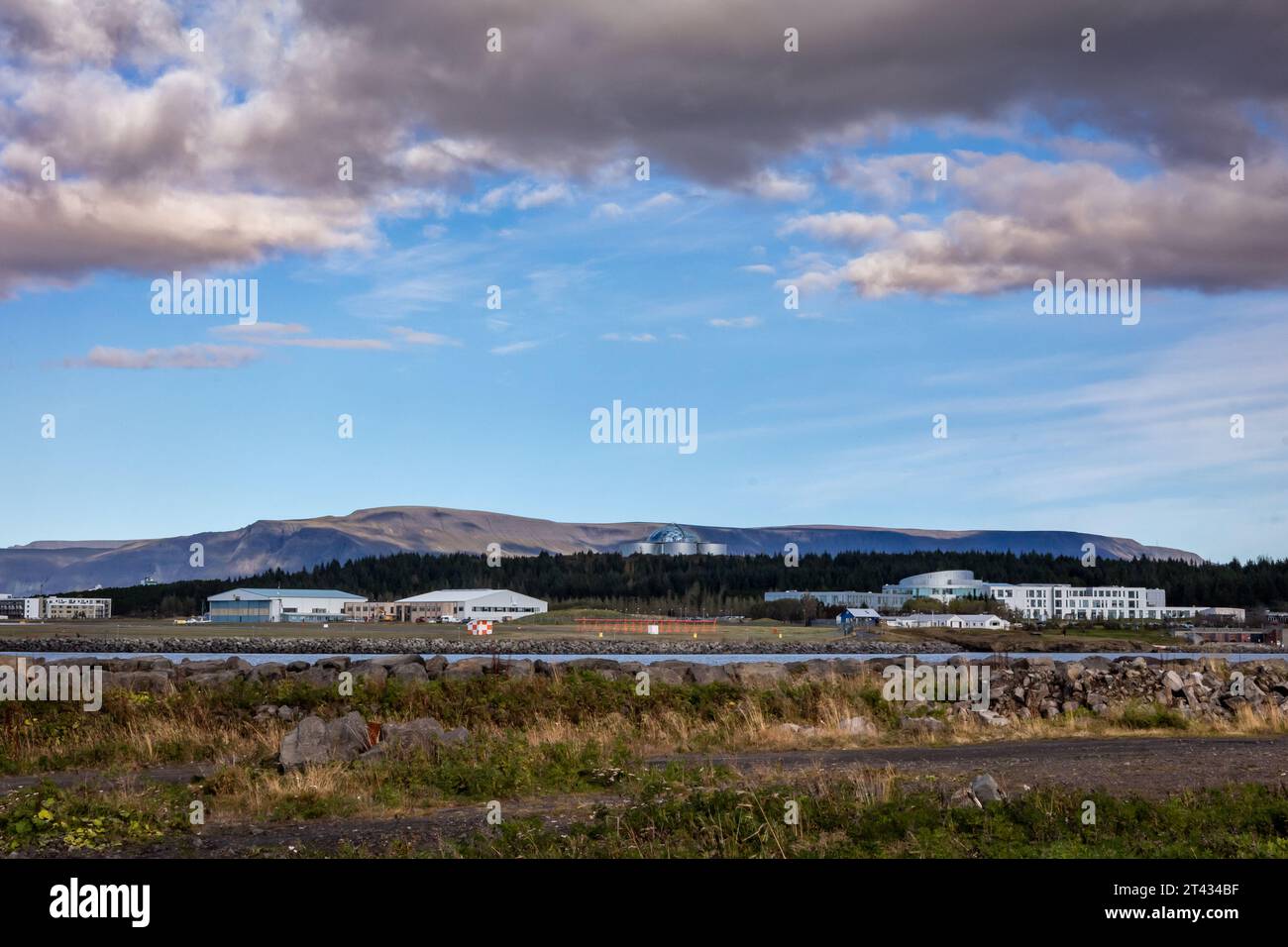Reykjavik, Iceland - September 25, 2023: Landscape with Reykjavik domestic airport and Perlan building, mountains in background. Stock Photo