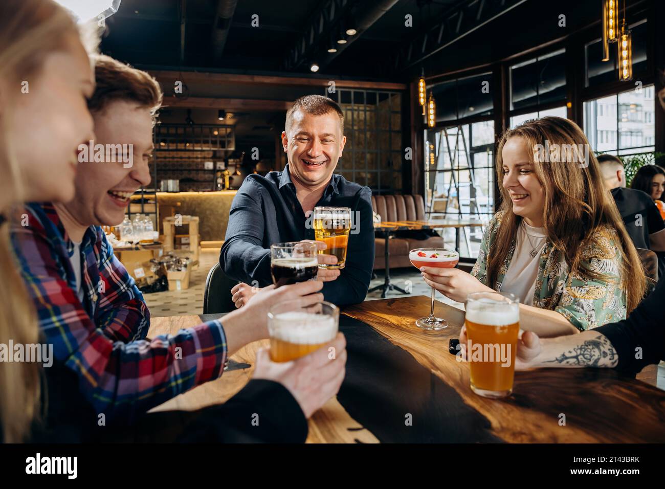 Cheerful friends enjoying party pub hi-res stock photography and images ...