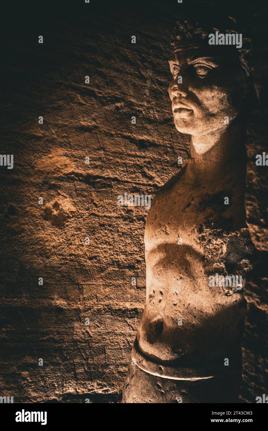 An intricately carved stone statue inside the Catacombs of Alexandria Stock Photo
