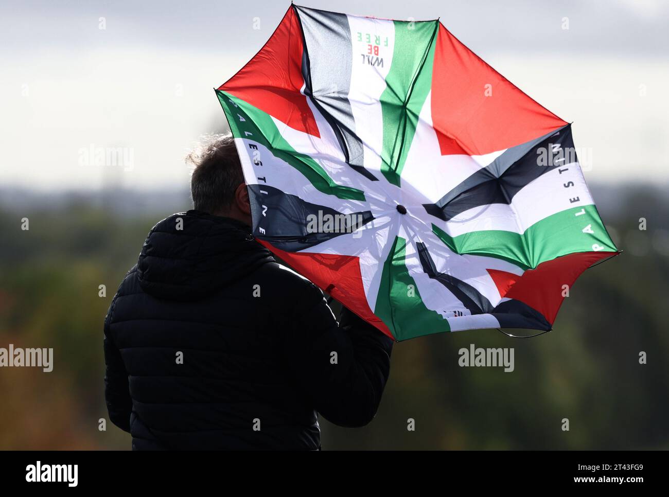 Leicester, Leicestershire, UK. 28th October 2023. A protesters umbrella is turned inside out during a pro-Palestinian demonstration and banner drop near to the base of UAV Tactical Systems. UAV Tactical Systems is an Israeli-French company manufacturing drones sold to the British army, Israel and international arms markets. Credit Darren Staples/Alamy Live News. Stock Photo