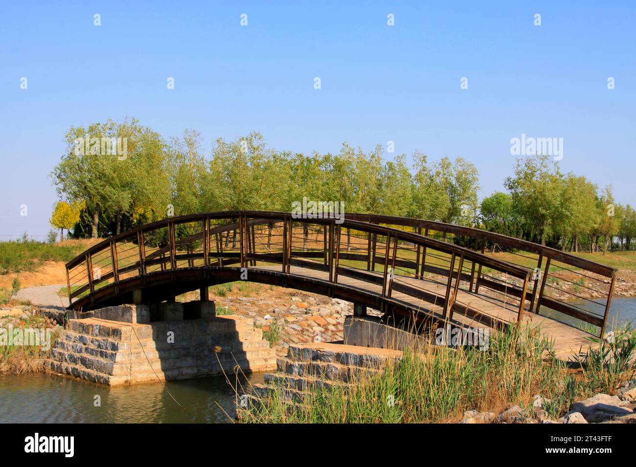 wooden arch bridge in a park, closeup of photo Stock Photo - Alamy
