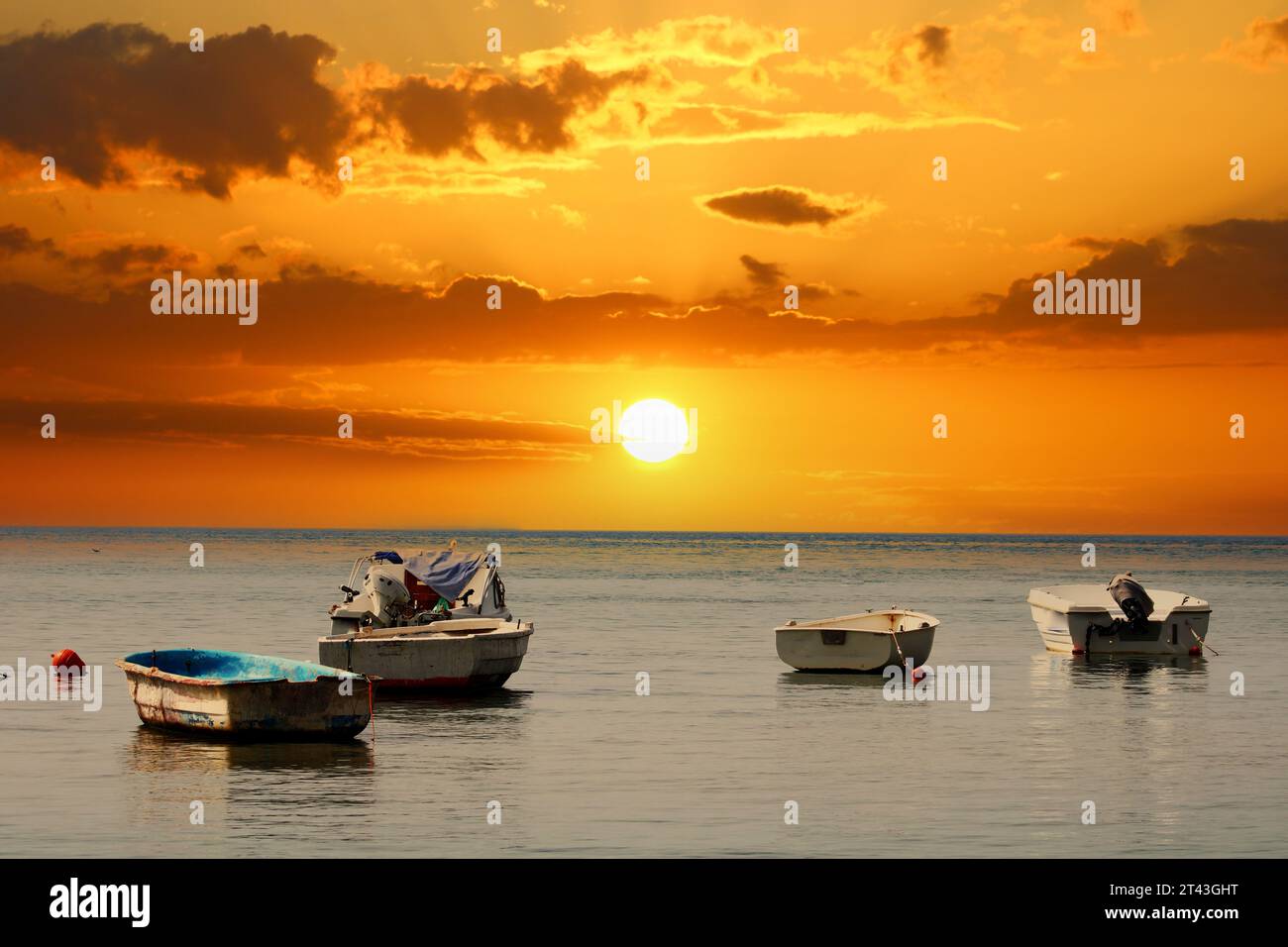 Fishing boats on the sea and the incredible sunset Stock Photo - Alamy