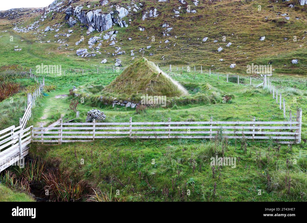 A view of a replica Iron Age house with design based on nearby Iron Age village remains by Bosta Beach, Great Bernera, Outer Hebrides, Scotland. Stock Photo