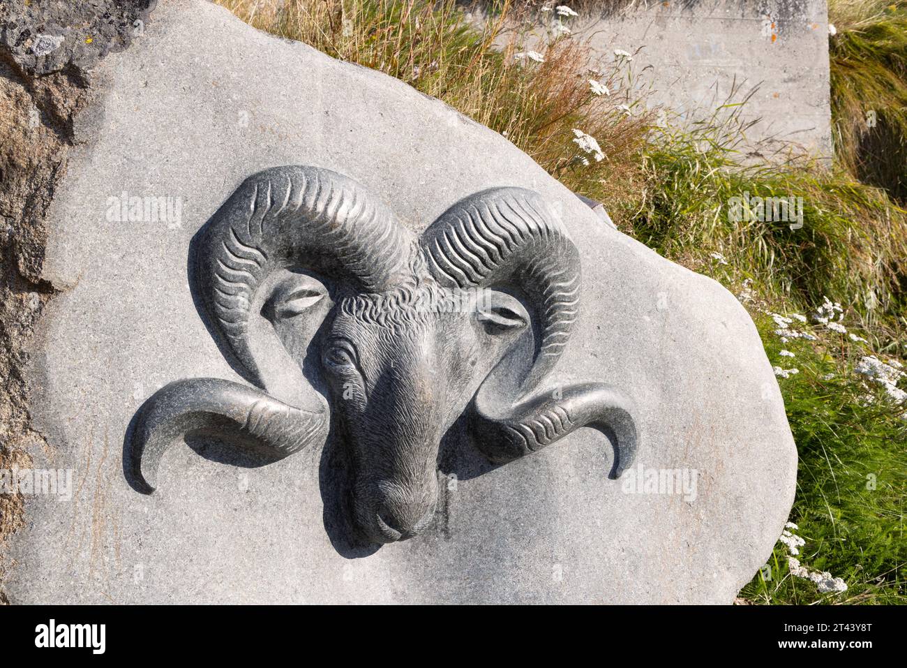Traditional inuit sculpture; Ram's head, part of the outdoor 'Stone and man' open air gallery of stone sculptures, Qaqortoq, Greenland Arctic Stock Photo
