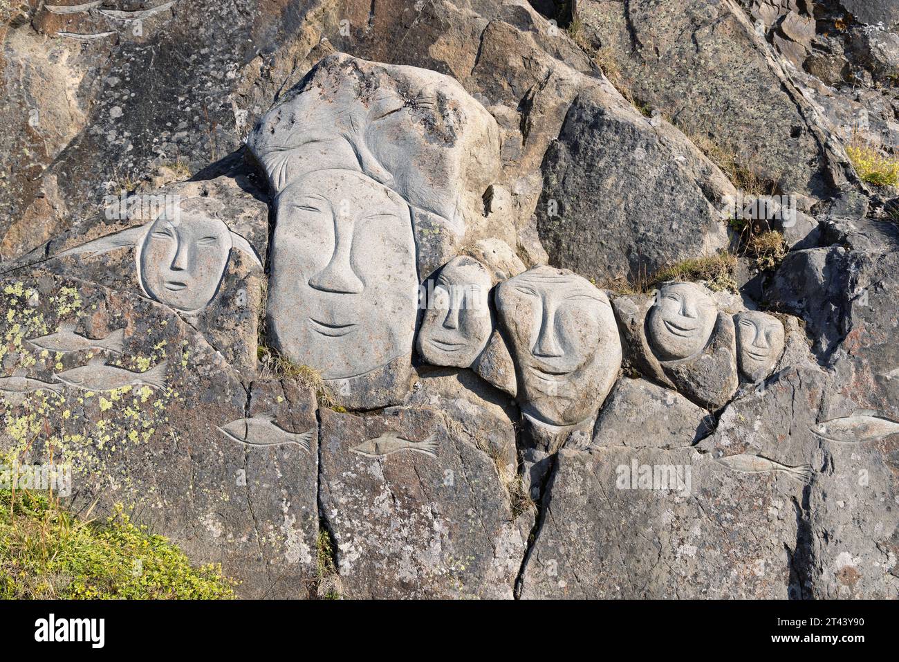 Traditional inuit sculpture; Stone faces, part of the outdoor 'Stone and man' open air gallery of stone sculptures, Qaqortoq, Greenland Arctic Stock Photo