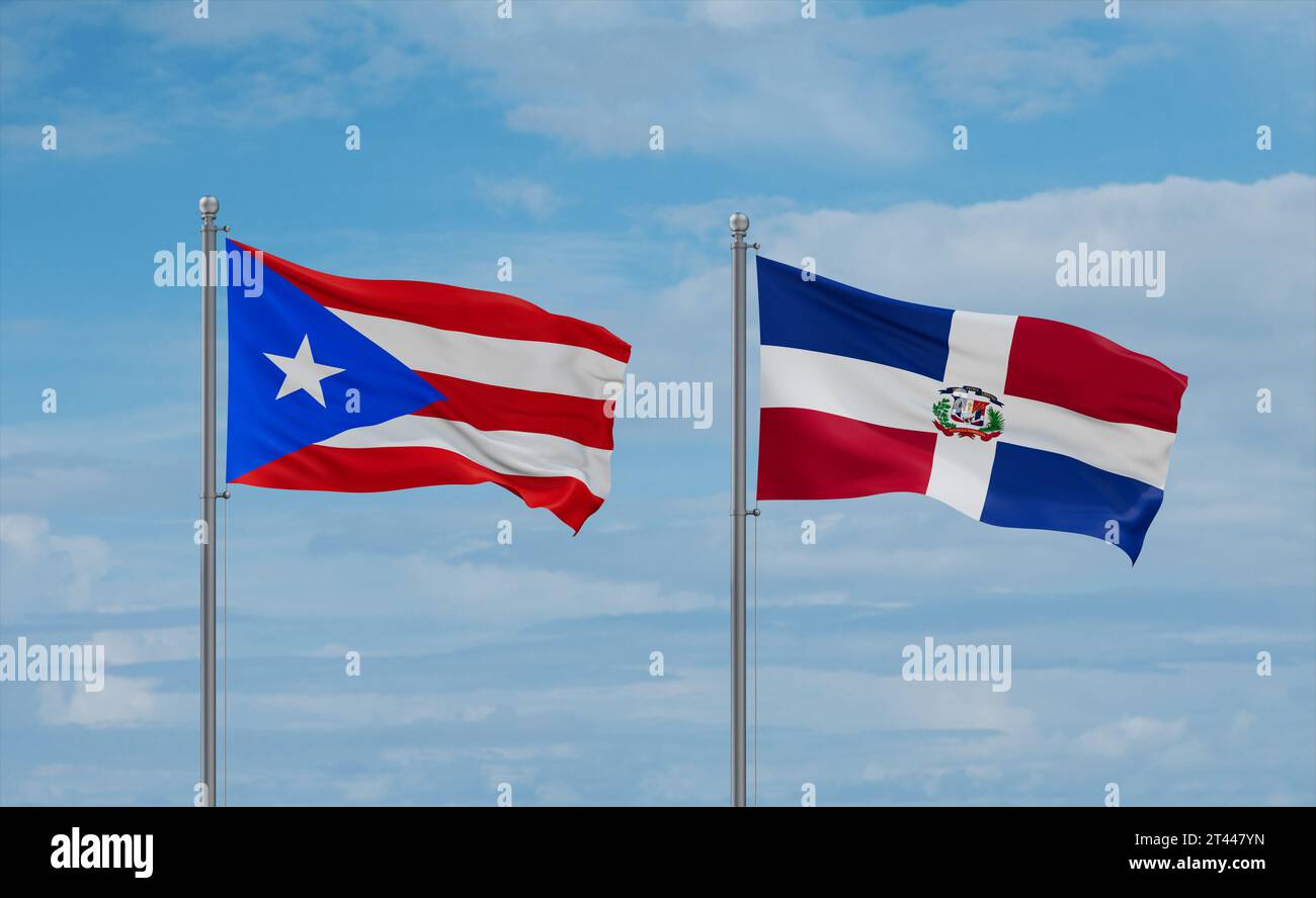 Dominican Republic and Puerto Rico flags waving together on blue cloudy sky, two country relationship concept Stock Photo