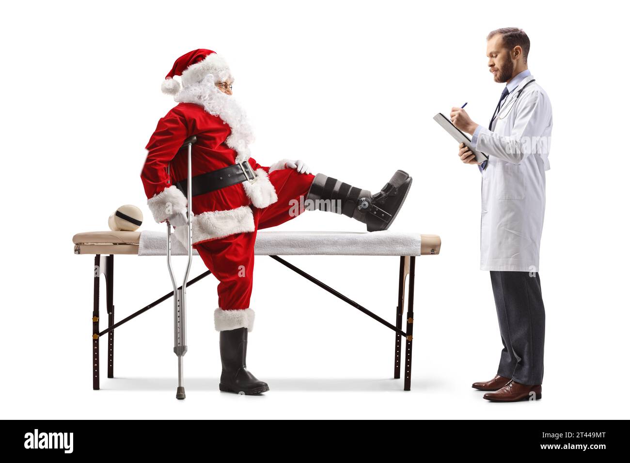 Doctor writing and standing in front of Santa claus with an injured leg isolated on white background Stock Photo