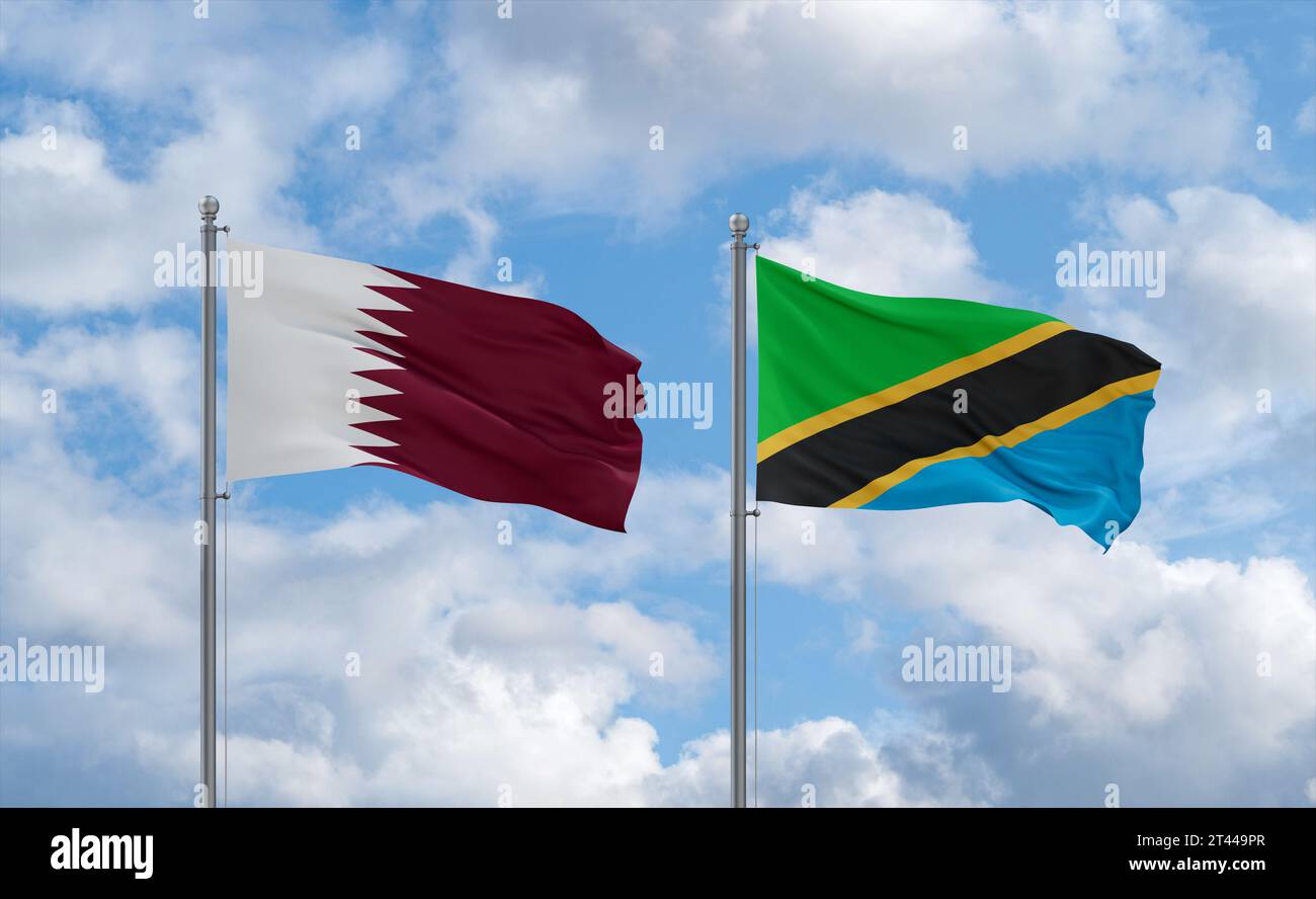 Tanzania and Qatar flags waving together in the wind on blue cloudy sky ...