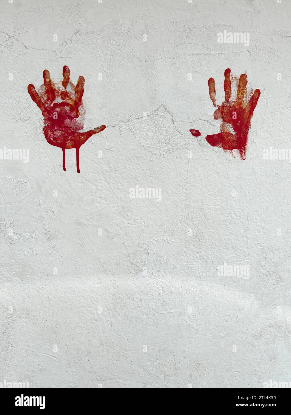 handprints, horror or Halloween background or surface with bloody red hands print on white wall with copy space. halloween background with hand shaped Stock Photo