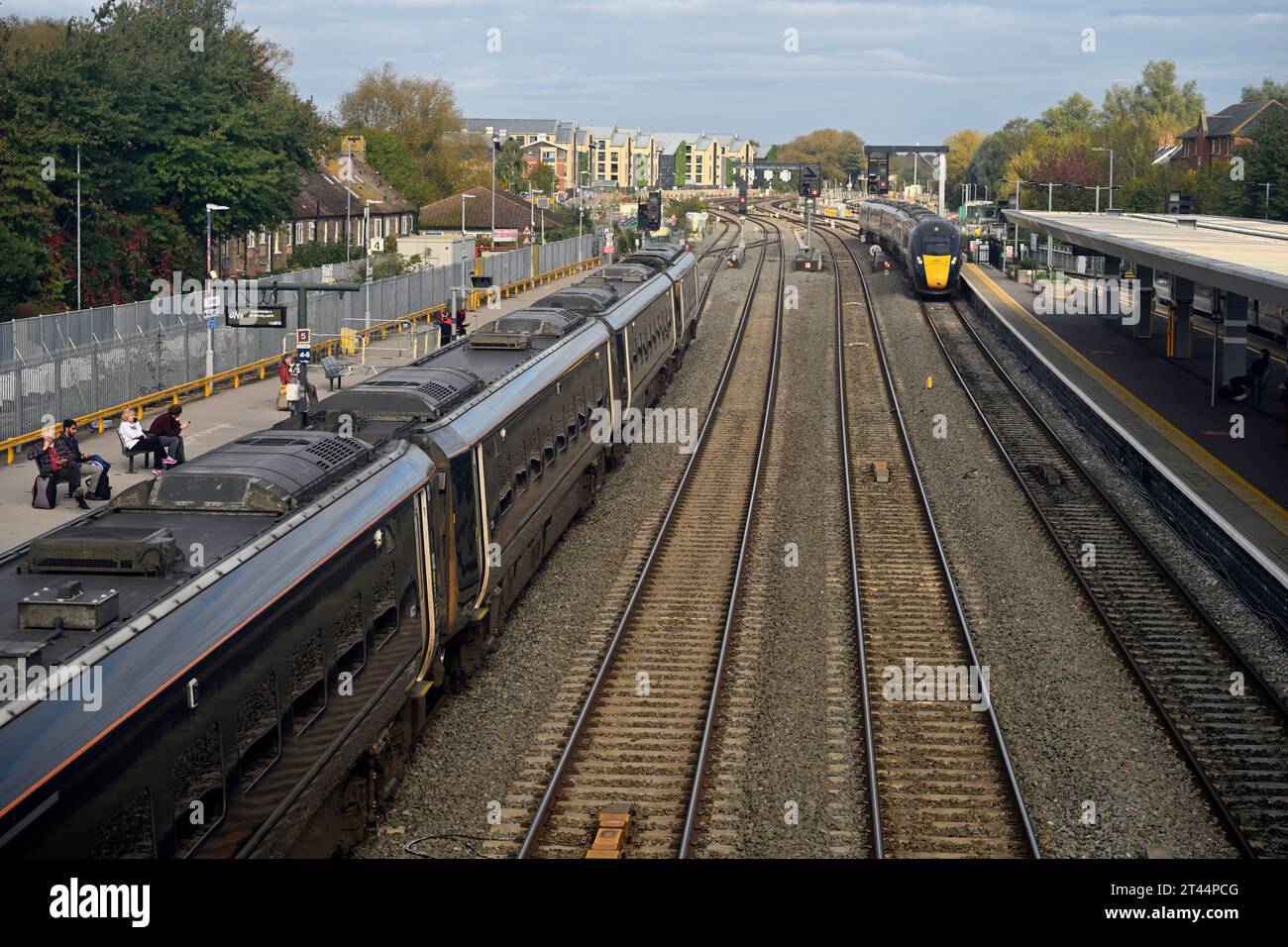 Two trains, one coming one going, at Oxford train station with tracks and platforms, UK Stock Photo