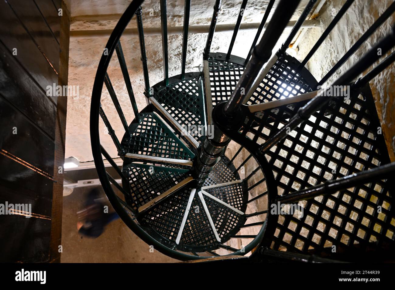 Looking down spiral metal staircase in bell town of historic church tower Stock Photo