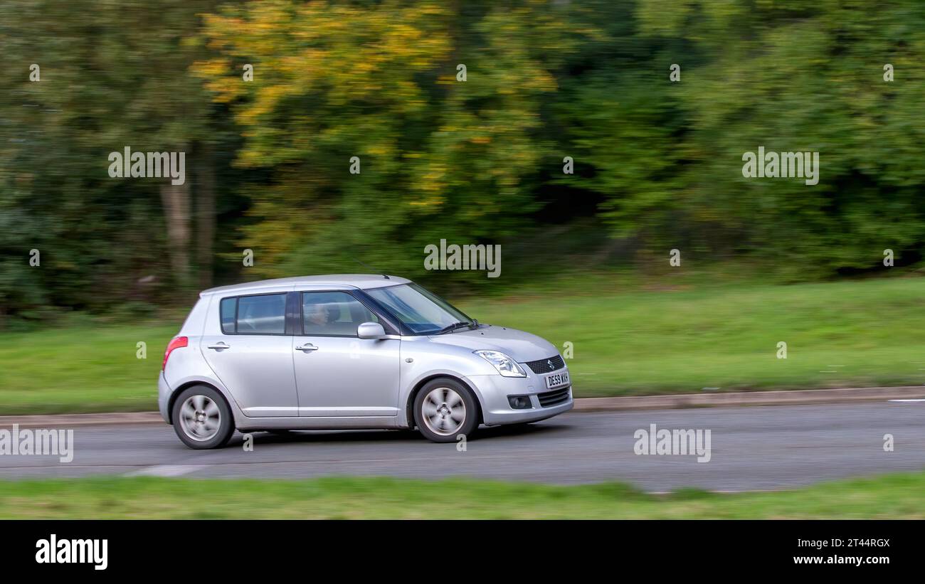 Milton Keynes,UK - Oct 28th 2023: 2009 silver Suzuki Swift car driving on an English road Stock Photo