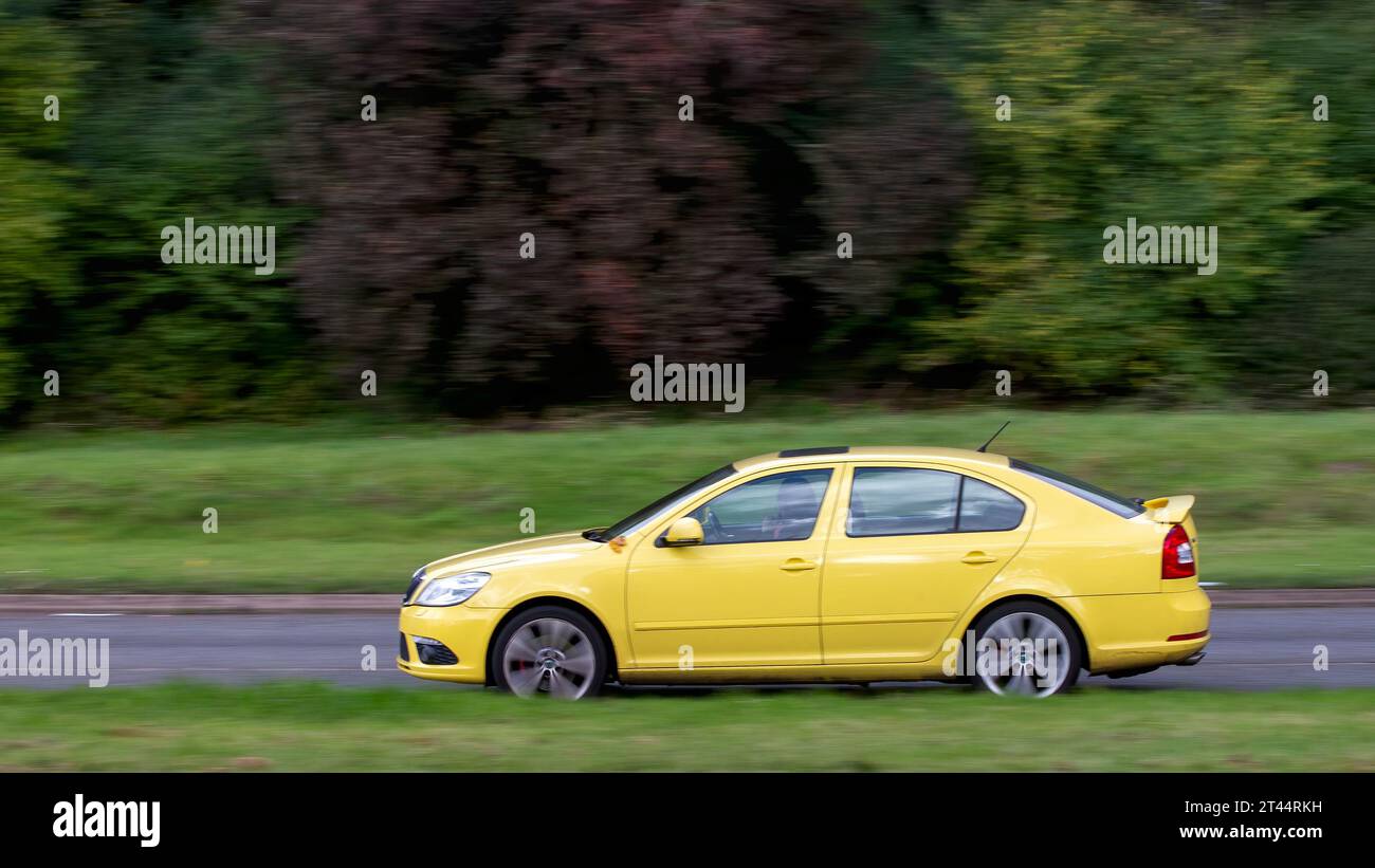Milton Keynes,UK - Oct 28th 2023: 2012 yellow diesel engine Skoda Octavia car driving on an English road Stock Photo