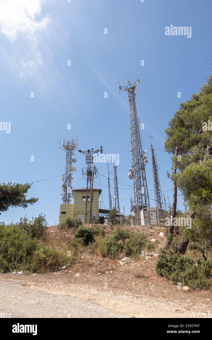 Telecommunication and electricity poles on the hill in Hatay Turkey Stock Photo