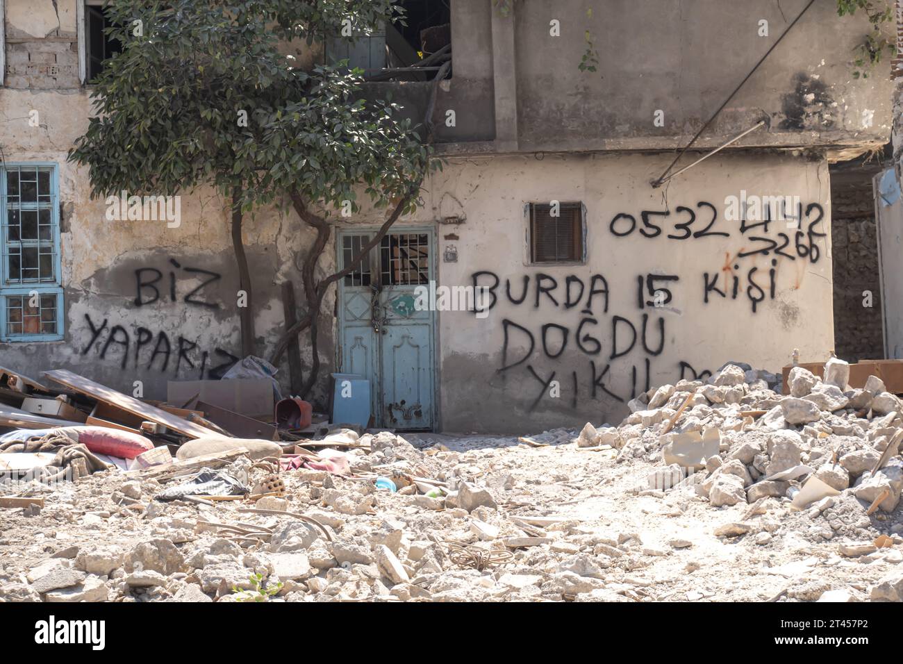 Destroyed house in Antakya with graffiti "15 people were born here' Hatay Turkey Stock Photo